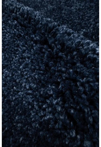 Blue rug texture detail with thick plush strands.