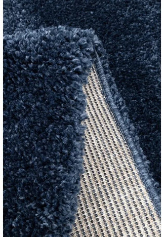 Detailed rug pile showing soft and fluffy blue material.
