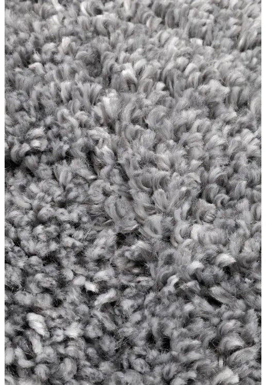 Close-up of soft shaggy fibers with dense grey texture.