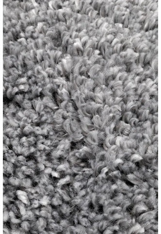 Close-up of soft shaggy fibers with dense grey texture.
