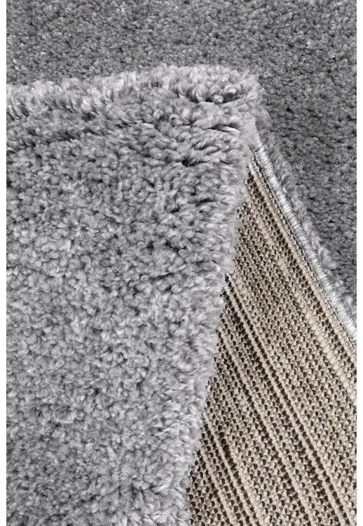 Detailed rug pile showing soft and fluffy grey material.