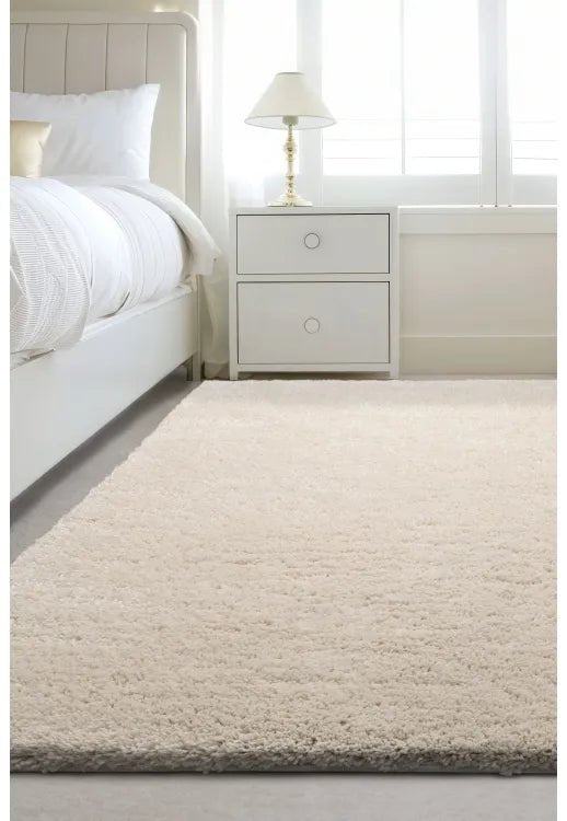 Luxury shaggy ivory rug with deep pile and soft plush texture.