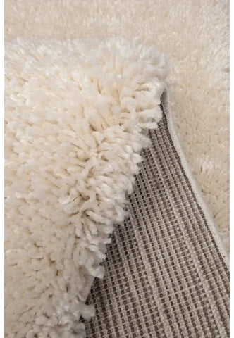 Ivory rug texture detail with thick plush strands.
