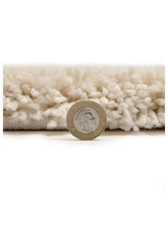 Plush rug texture close-up with warm ivory finish.