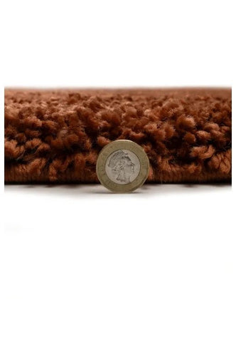 Shaggy rug close-up showing deep pile and soft terra fibers.