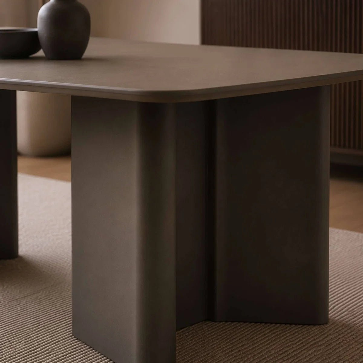 Dark brown table with a minimalistic design in a room setting.