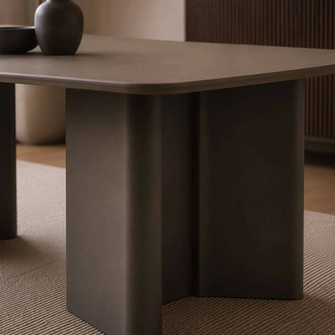 Dark brown table with a minimalistic design in a room setting.
