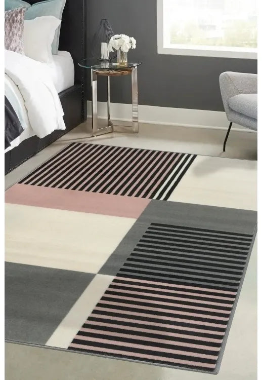 Blush rug with modern barcode inspired striped design.