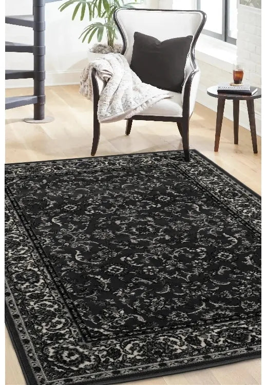 Dark grey rug with intricate traditional Beluchi pattern design.