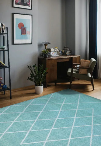 Teal rug with Berber inspired geometric pattern design.
