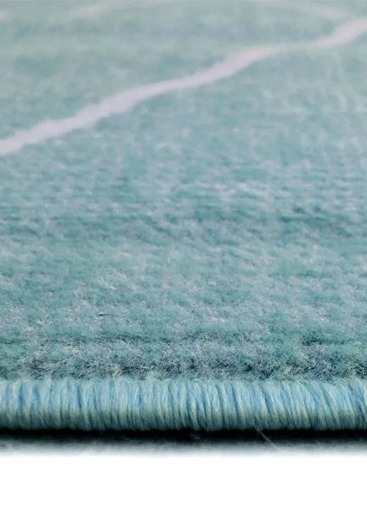 Decorative teal rug with striking Berber design.