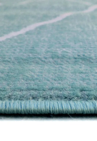 Decorative teal rug with striking Berber design.