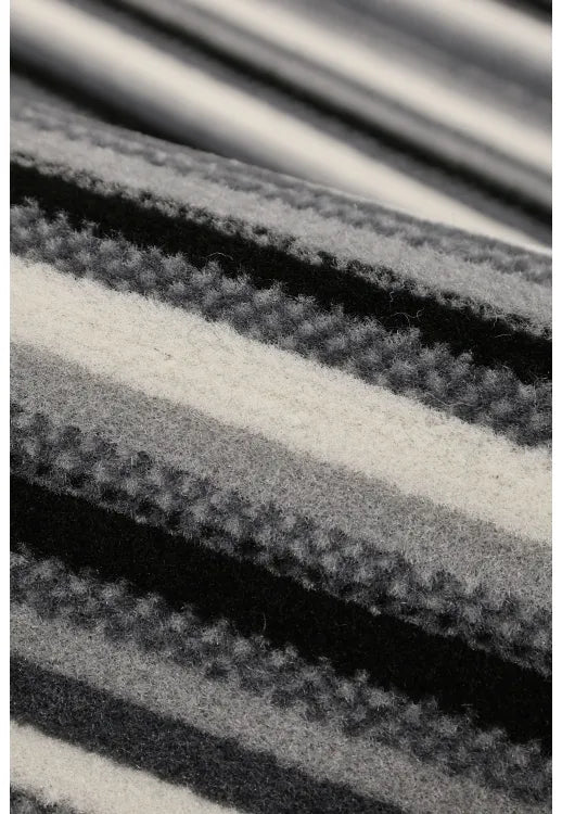 Modern grey rug adding texture and sophistication.