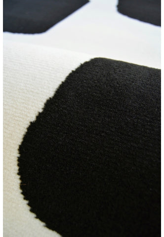 Contemporary rug with modern geo block detailing in black tones.