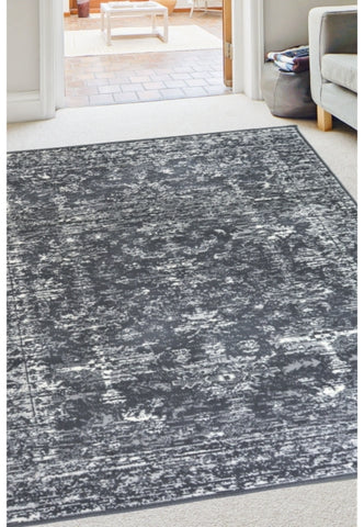 Charcoal rug with traditional inspired pattern.
