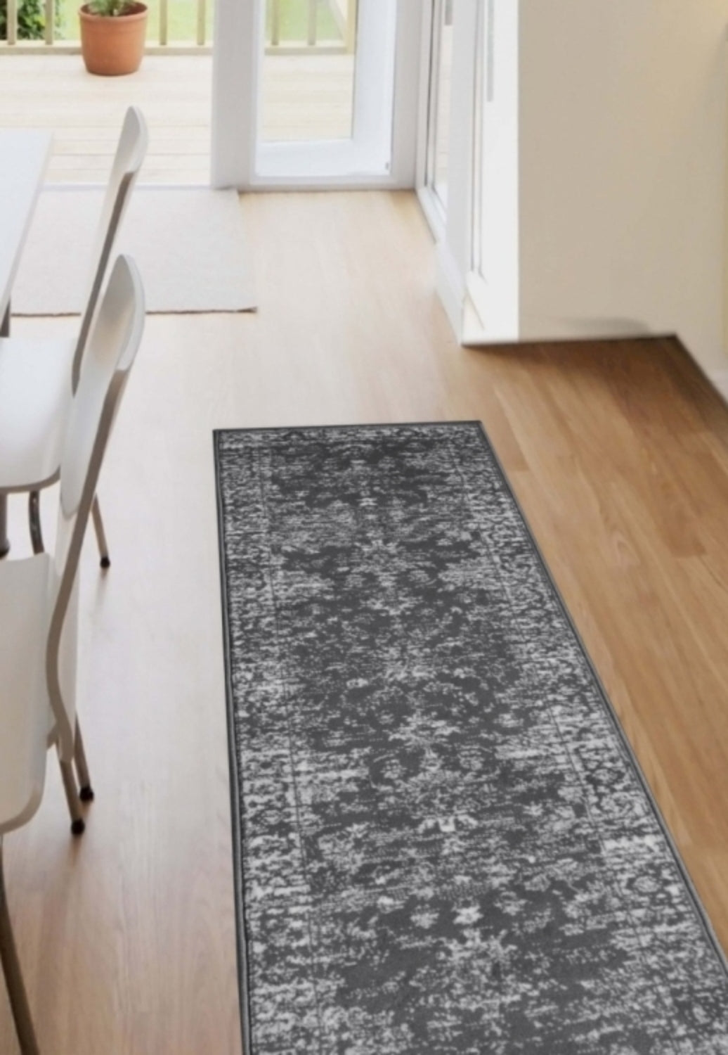 Charcoal runner rug with traditional pattern and durable polypropylene fabric.