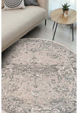 Round cream rug with traditional pattern and durable polypropylene fabric.