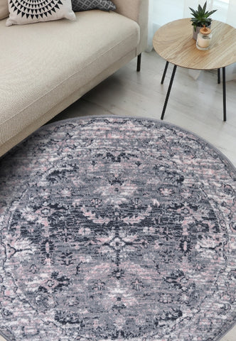 Round grey rug with traditional inspired pattern.