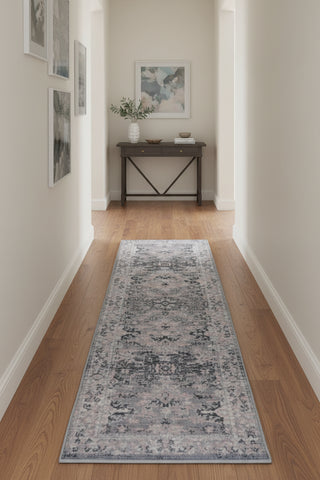 Grey runner rug with traditional inspired pattern.