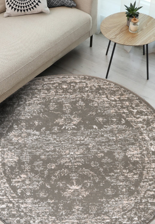 Round natural rug with traditional inspired pattern.