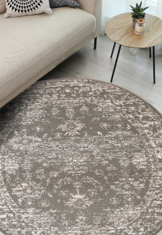 Round natural rug with traditional inspired pattern.