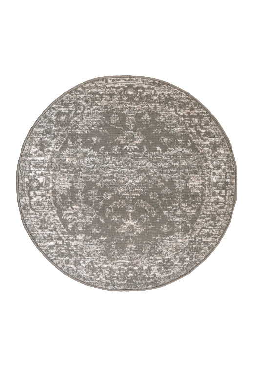 Circular rug with classic design in warm neutral tones.