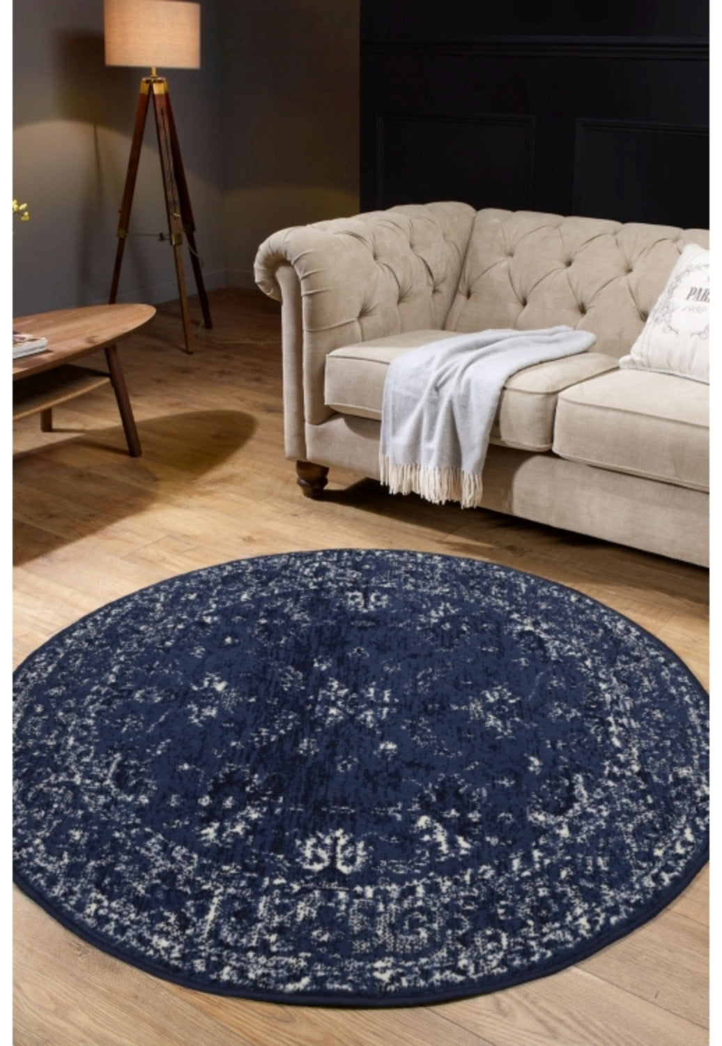 Round navy rug with traditional inspired pattern.