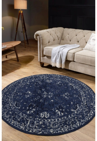 Round navy rug with traditional inspired pattern.