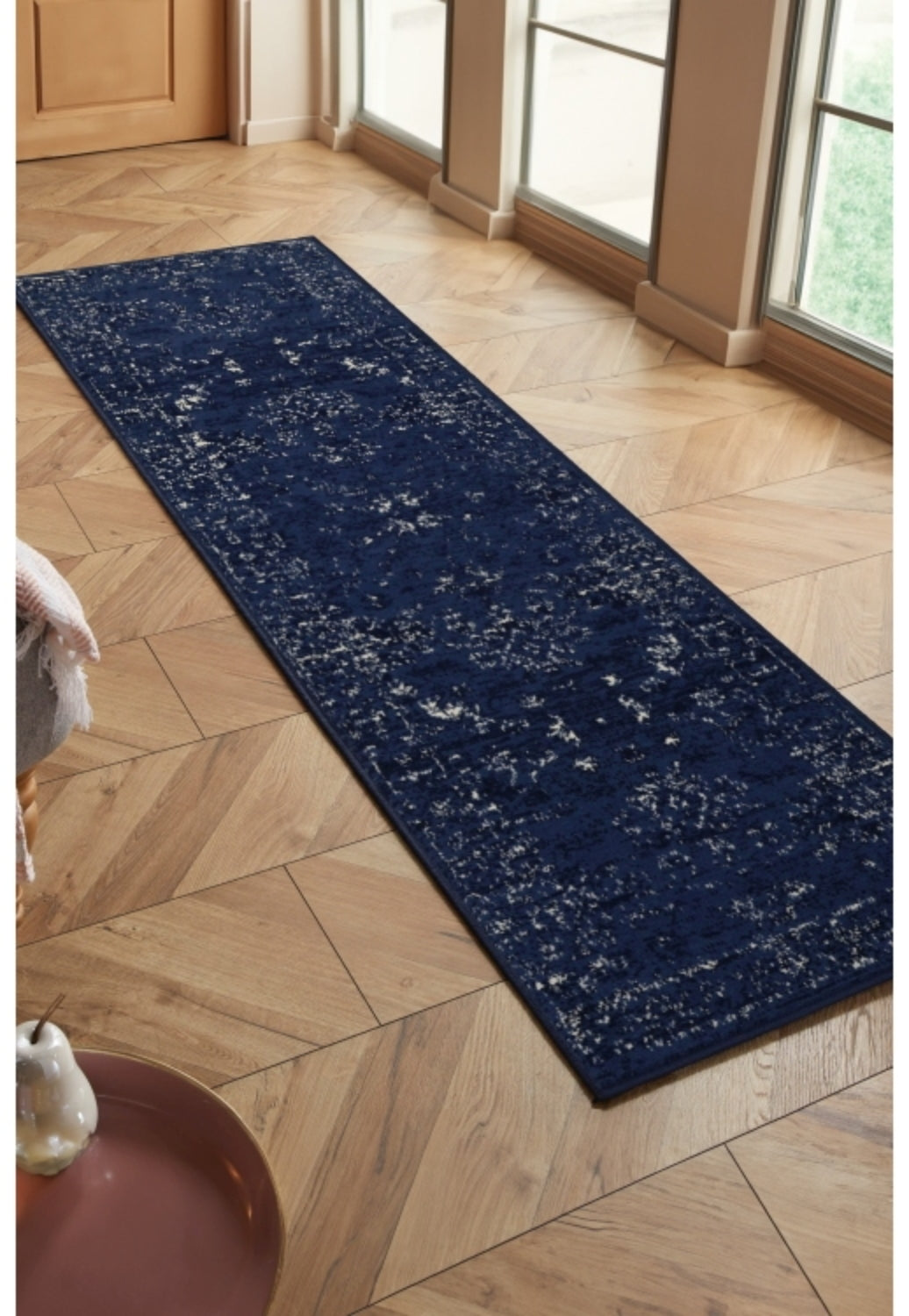 Navy runner rug with traditional inspired pattern.