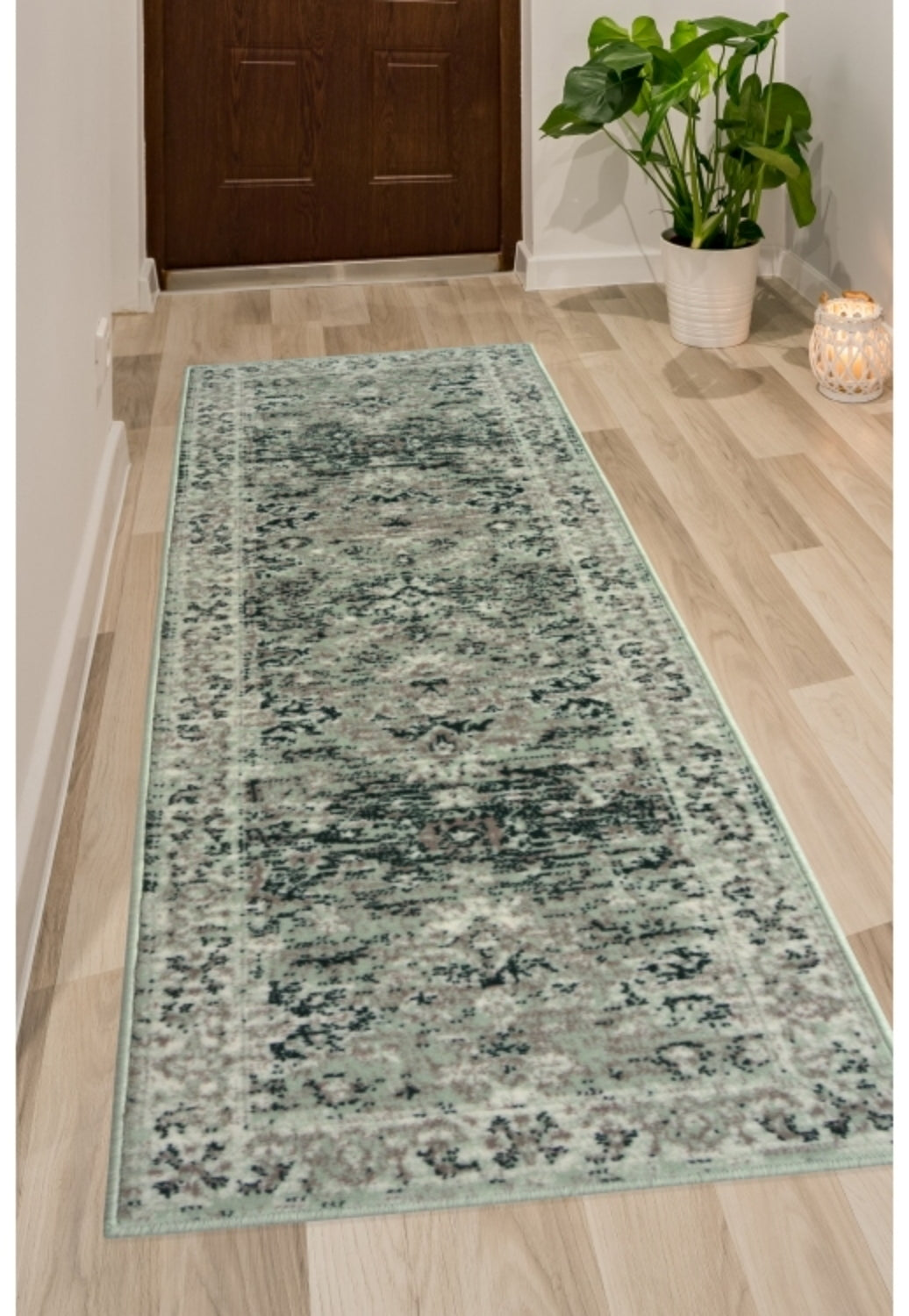 Sage green runner rug with traditional inspired pattern.