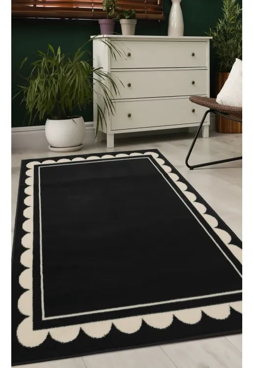 Black rug with stylish scallop inspired pattern design.