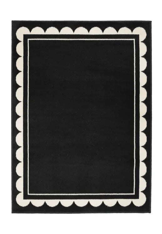 Contemporary rug with subtle scallop detailing in black tones.