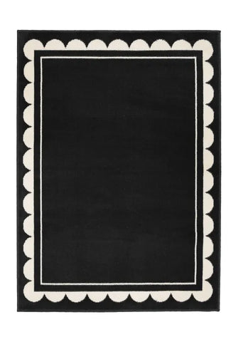 Contemporary rug with subtle scallop detailing in black tones.