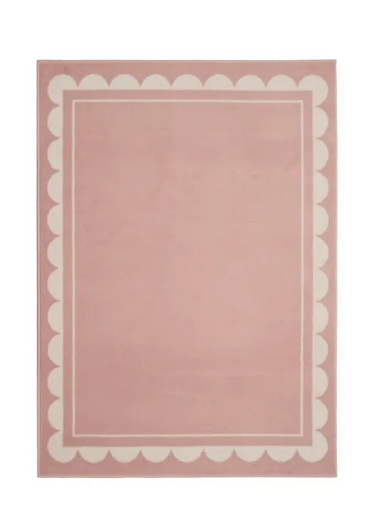 Contemporary rug with soft scallop detailing in blush tones.