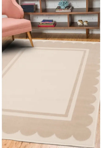Natural rug with elegant scallop border design.