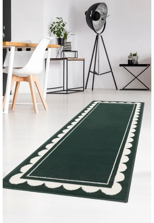 Green runner rug with stylish scallop pattern design.