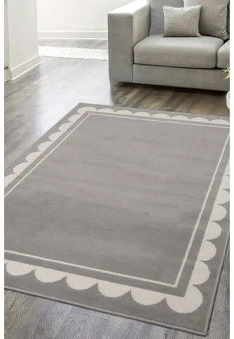 Grey rug with stylish scallop inspired pattern design.