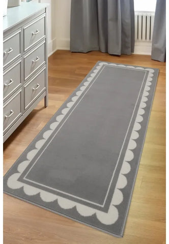 Grey runner rug with stylish scallop pattern design.