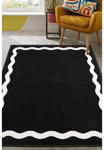 Black rug with bold scallop outline pattern design.