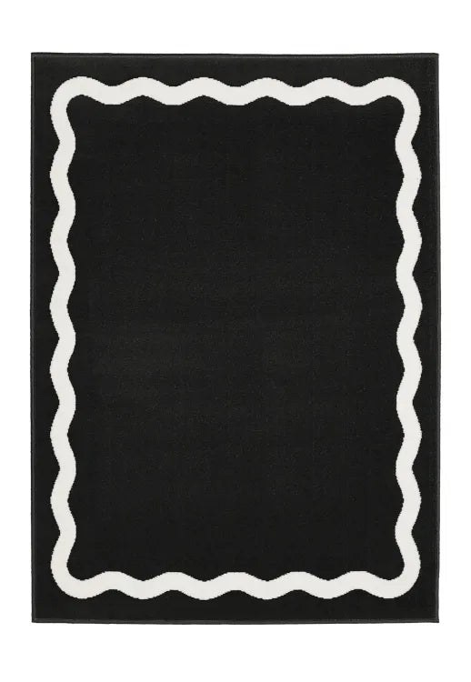Modern black rug with clean lined scallop pattern.
