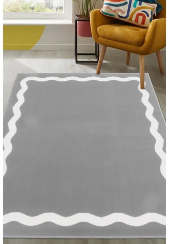 Grey rug with elegant scallop outline pattern design.
