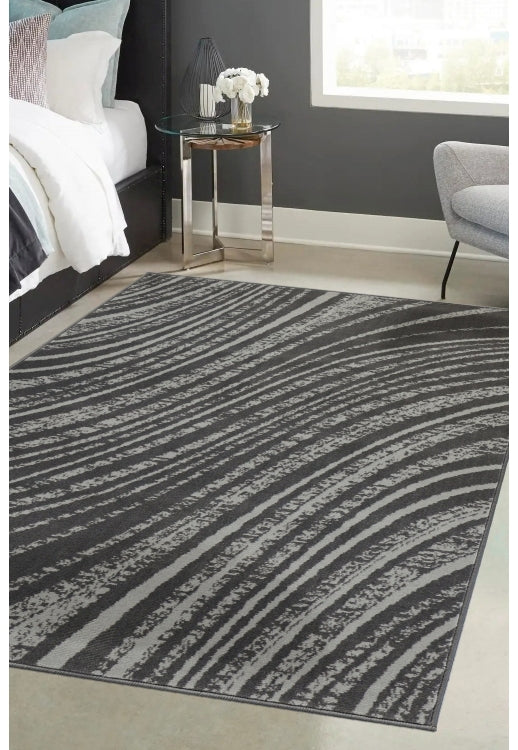 Charcoal rug with modern swirl pattern design.