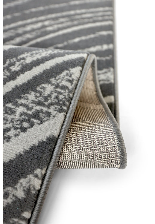 Abstract swirl rug in deep charcoal tones.