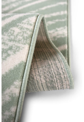 Modern sage rug adding texture and movement.