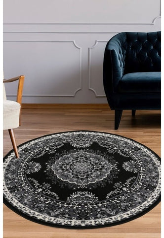 Round black and grey rug with geometric pattern design.