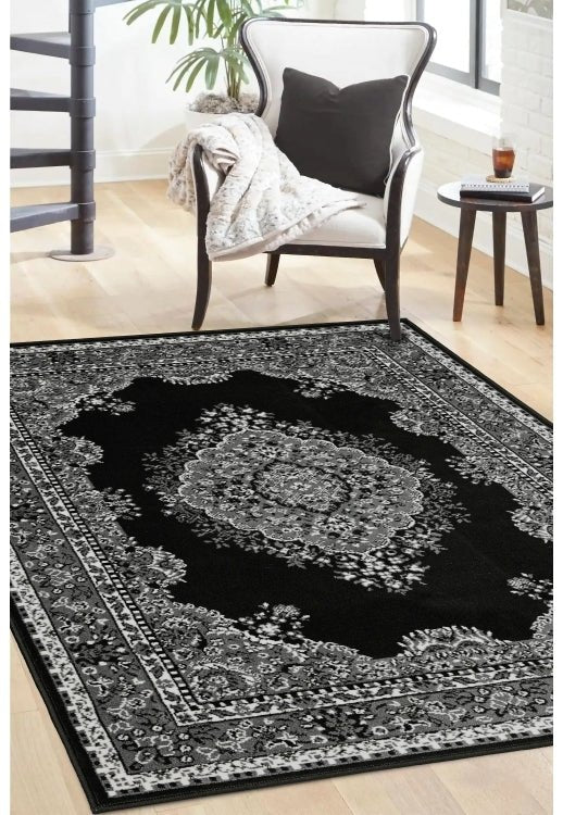 Black and grey rug with bold geometric pattern design.