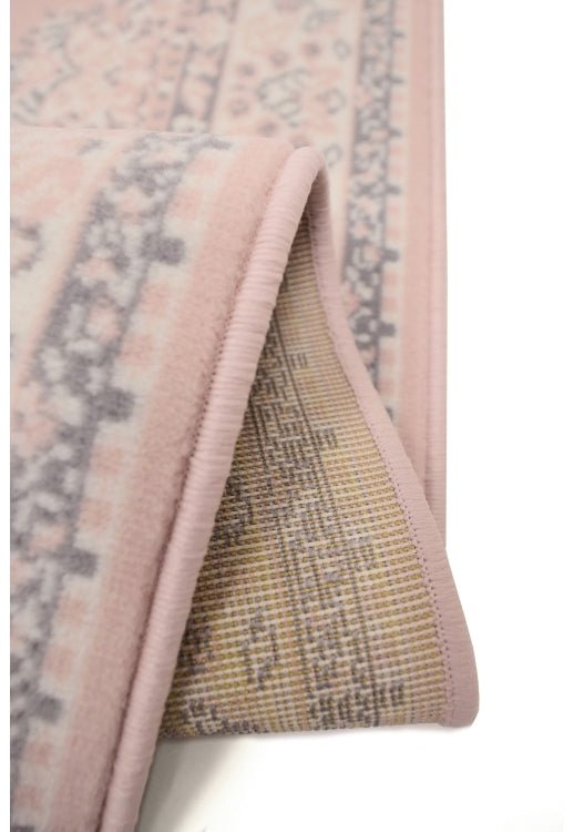 Subtle patterned rug in delicate blush tones.