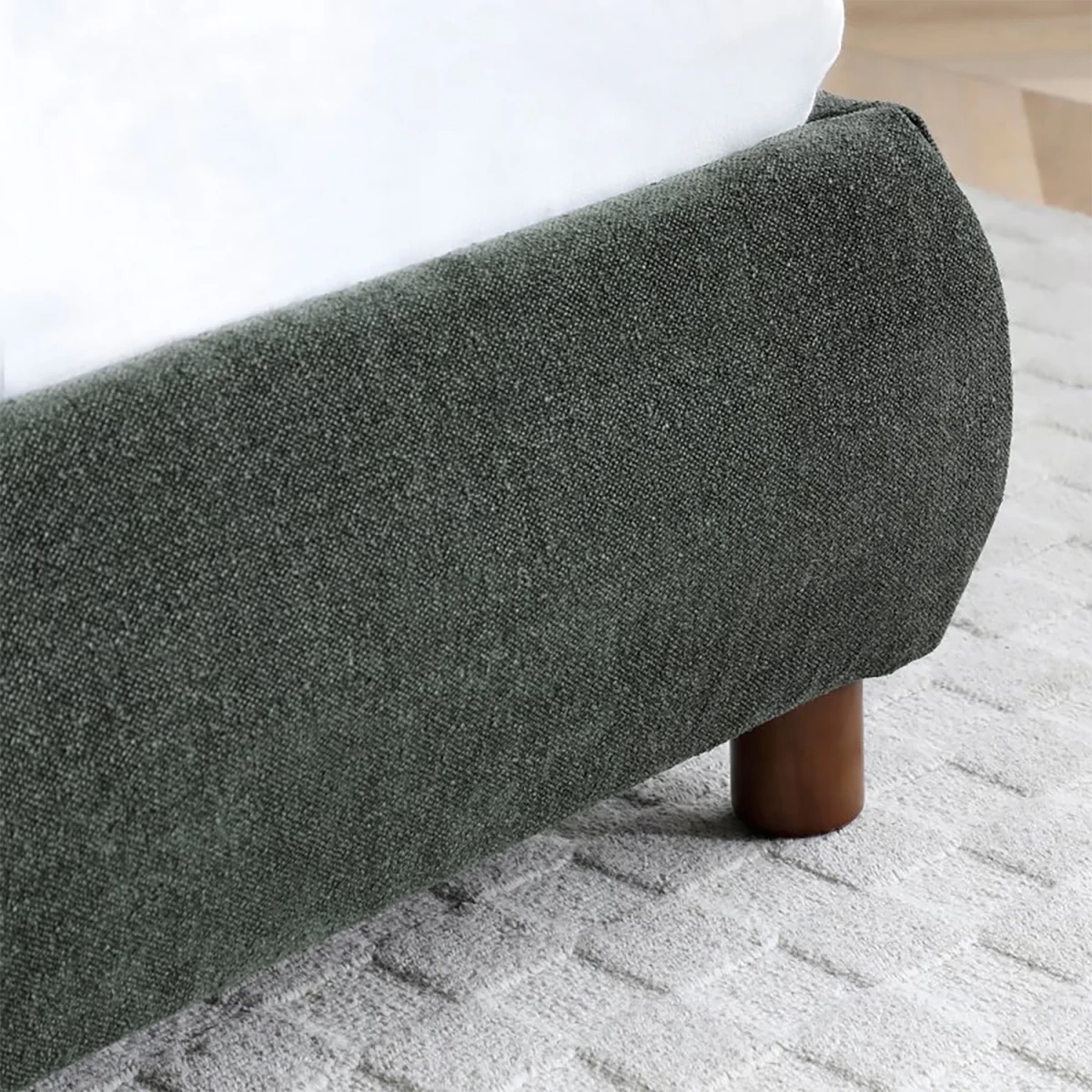 Close up of the wooden legs on the Mallow Olive Boucle Fabric Upholstered Bed 