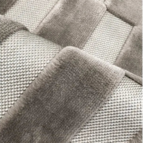 Modern grey rug with subtle patterned detailing.