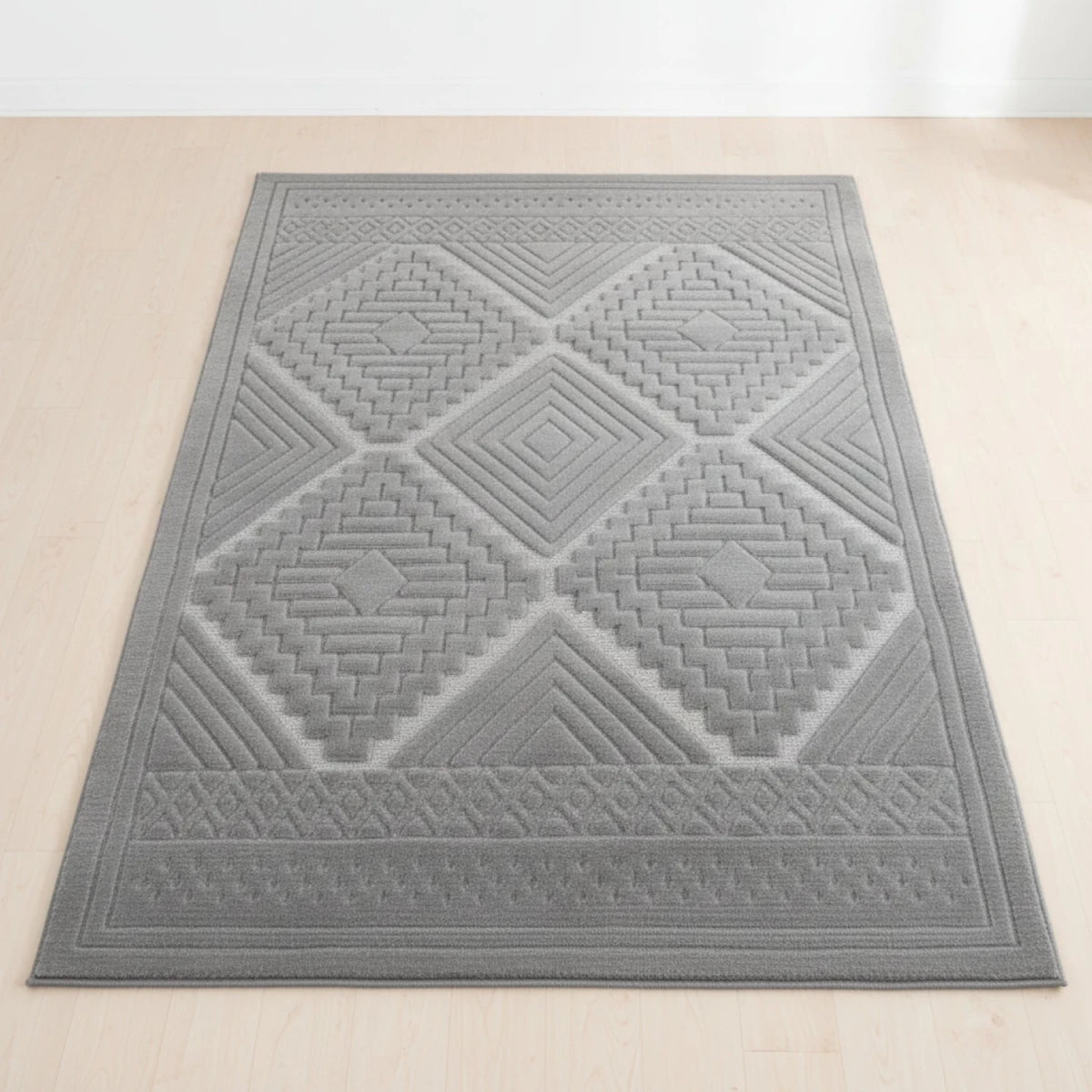 Grey rug with tribal inspired pattern and modern design.